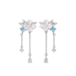 Floral silver needle earrings with blue zircon accents and cascading tassel chains