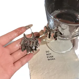 Elegant silver tassel hoop earrings with metallic fringe details for a modern style.