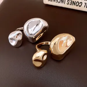 Anelli aperti irregolari e increspati in finitura oro e argento con texture metallica
