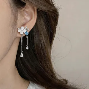 Close-up view of elegant silver needle flower tassel earrings with zircons for women