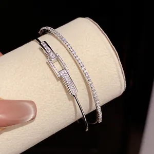Close-up macro shot of elegant silver-plated open bangles featuring square-cut zircon stones
