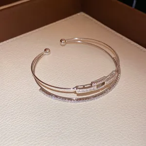 Close-up of elegant square zircon elements on a 18k gold-plated double-layer open bangle