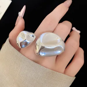 Primo piano di un anello aperto chic in metallo liquido argento irregolare da donna