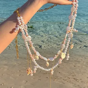 Detailed view of beach vacation style pearl and shell tassel body chain for women