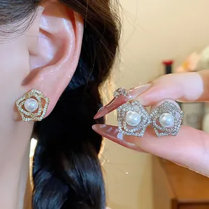 Detail shot of French-style floral pearl earrings with sparkly rhinestone paving