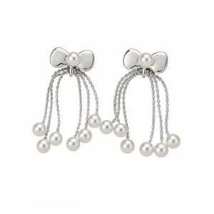 Elegant bow pearl tassel stud earrings with a minimalist silver-tone finish on white background