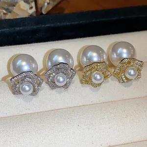 Detailed macro view of elegant flower pearl earrings in both gold and silver plating