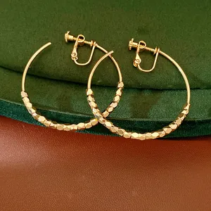 Detail view of 14K gold plated faceted bead hoop ear clips with clip-on back mechanism.