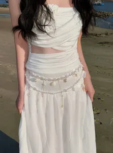 Detailed view of beach vacation style pearl and shell tassel body waist chain