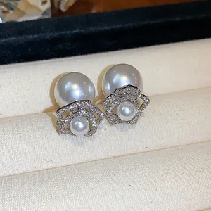 Detailed view of 14K gold plated flower pearl earrings with sparkling pavé crystals