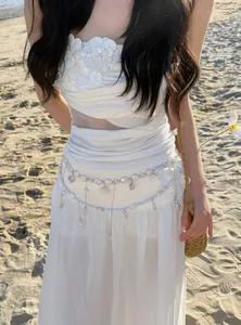 Elegant pearl and shell tassel waist chain accessory for beach vacation outfit styling.
