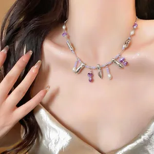 Elegant close-up of minimalist acrylic pearl and silver beaded necklace on model's neck.