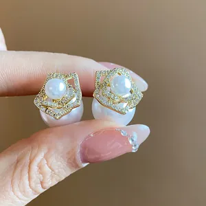 Detailed macro view of elegant flower pearl earrings with 14k gold plating
