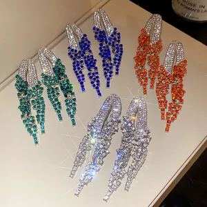 Detail shot of elegant geometric tassel earrings with colorful sparkling rhinestones.