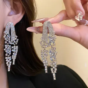 Detailed macro view of vintage geometric fringe earrings encrusted with sparkling crystals
