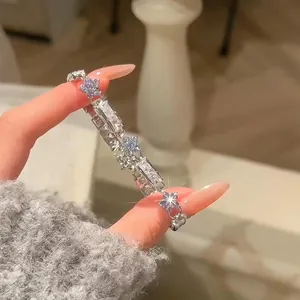 Detail view of a dainty Korean style silver flower bracelet with sparkling zircons