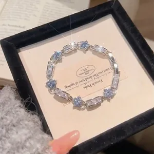 Exquisite Korean style silver bracelet with blue flower zircon in a black jewelry box