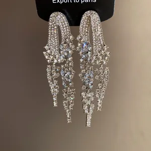 Detailed view of silver-toned geometric tassel earrings with brilliant rhinestone inlay