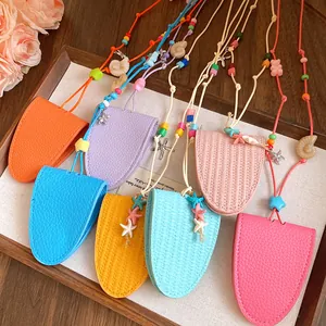 Colorful leather eyeglass holder necklaces with starfish and shell charms in a tray.