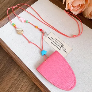 Close-up detail of pink leather eyeglass holder necklace with starfish and seashell charms