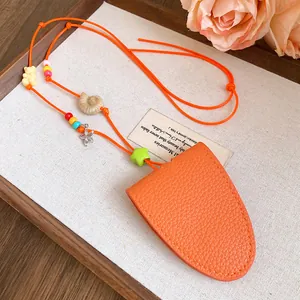 Close-up of orange leather sunglasses holder necklace with colorful beads and starfish charm.