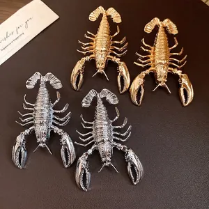 Statement retro lobster stud earrings in gold and silver finish with vintage metal texture
