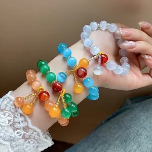 Vintage colorful cat eye stone beaded bracelets with handcrafted cord tassels on wrist