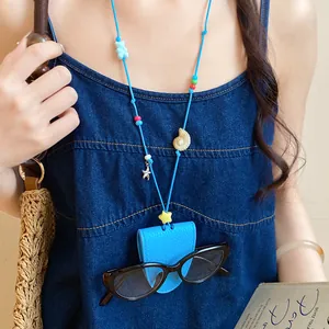 Close-up detail of blue leather sunglasses clip necklace with starfish charm and beads