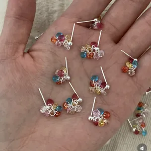 Detailed view of sweet forest style dopamine colorful zircon cluster stud earrings on hand