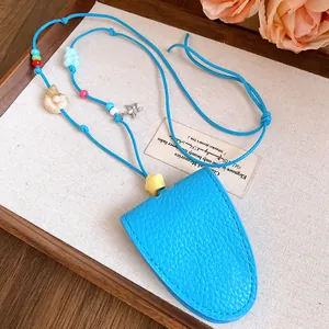 Close-up of blue leather sunglasses holder necklace with starfish and shell charms.