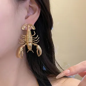 Statement vintage gold metal lobster earrings for women with bold artistic design