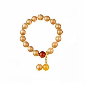 Vintage minimalist cat-eye stone beaded bracelet with gold pendant and red accent bead.