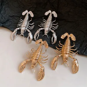 Detailed macro view of vintage metal lobster earrings in gold and silver finishes