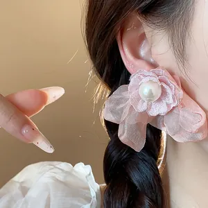 Detailed view of an elegant pink chiffon flower stud earring featuring a white pearl center