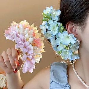 Elegant fabric flower hairpins in pink and blue for beautiful vintage hair styles.