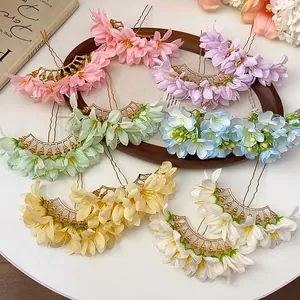 Detailed view of colorful fabric flower hairpins in multiple elegant pastel shades.