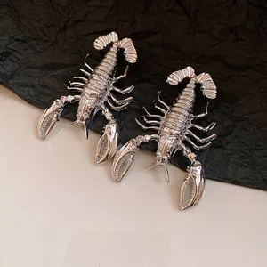 Detailed macro view of vintage silver lobster-shaped earrings with metallic finish
