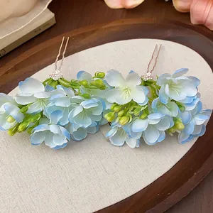 Close-up of elegant blue and white fabric floral hair pins for vintage styles