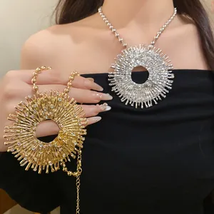 Close-up detail of vintage sunburst pendant necklace with rhinestones in gold and silver