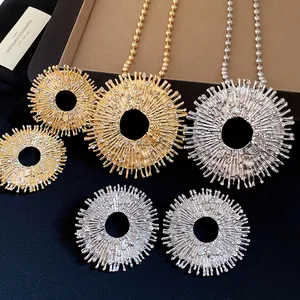 Detailed view of sunburst bee pendant necklace with rhinestones in gold and silver