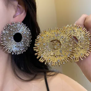 Detailed view of gold and silver sunburst bee earrings with sparkling rhinestones.