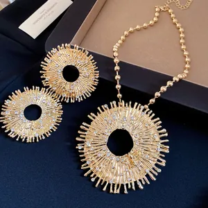 Detailed macro shot of vintage gold sunburst necklace and earrings with rhinestone bee motif.