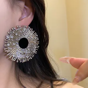 Close-up of vintage sunburst statement earrings with shimmering rhinestone embellishments