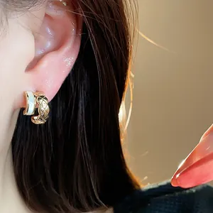 Elegant 18k gold-plated C-shaped stud earring with a signature quilted pattern detail