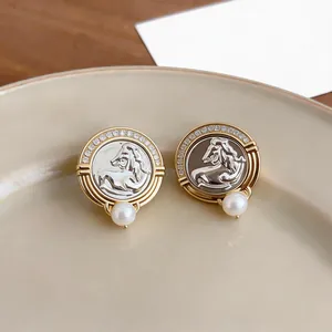 Exquisite detail of vintage gold horse head stud earrings with pave zirconia and pearls