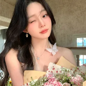 Asian model wearing elegant pearl flower tassel earrings and a necklace with pink flowers