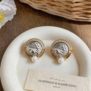 Close-up of French vintage horse head earrings with zircon and pearl details