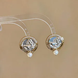 Macro view of French vintage horse head earrings with zircon halo and white pearl