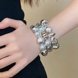 Vintage irregular geometric beaded bracelet with pearls and silver-textured charms