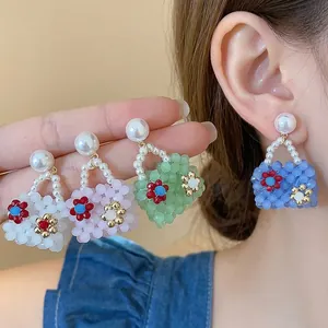 Colorful handbag-shaped pearl stud earrings with delicate floral beaded accents